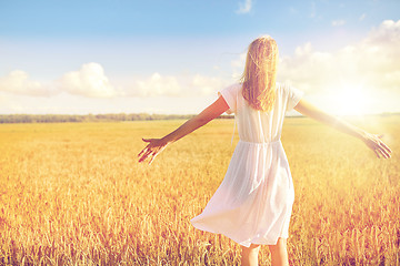 Image showing happy young woman in white dress on cereal field