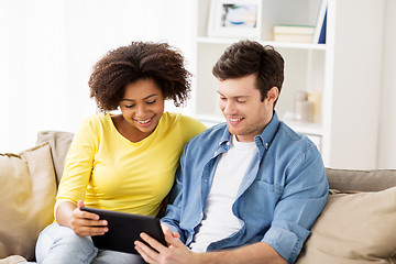 Image showing smiling happy couple with tablet pc at home