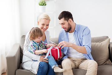 Image showing happy family with birthday gift at home