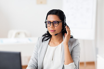 Image showing businesswoman with headset talking at office