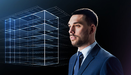 Image showing businessman in suit with virtual building hologram