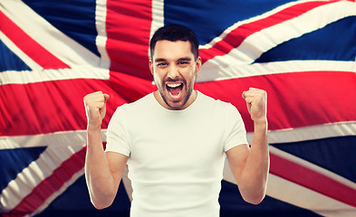 Image showing angry man showing fists over brittish flag