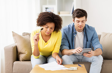 Image showing couple with papers and calculator at home