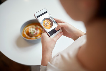 Image showing woman with smartphone photographing food at cafe