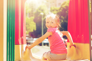 Image showing happy little girl on slide at children playground