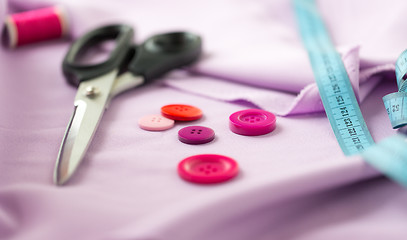 Image showing scissors, sewing buttons, tape measure and cloth