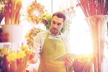 Image showing man with tablet pc computer at flower shop