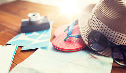Image showing close up of travel map, flip-flops, hat and ticket