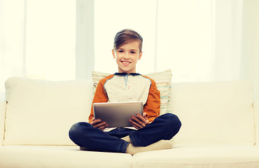 Image showing smiling boy with tablet computer at home