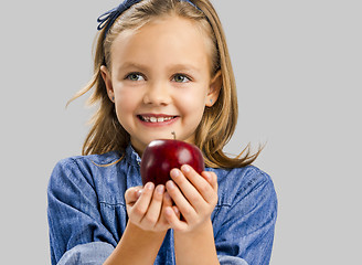 Image showing Cute girl holding an apple