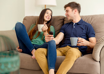 Image showing Watching tv and drinking coffee