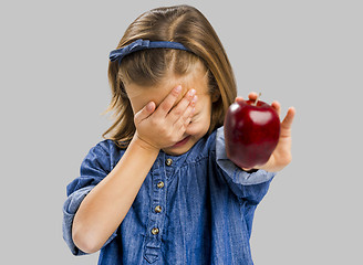 Image showing Cute girl holding an apple