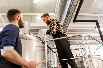 Image showing men working at craft brewery or beer plant