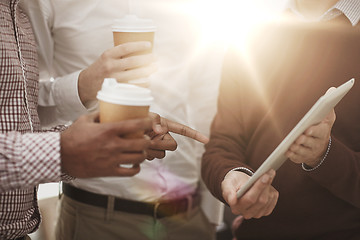 Image showing business team with tablet pc and coffee at office