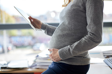 Image showing pregnant businesswoman with tablet pc at office