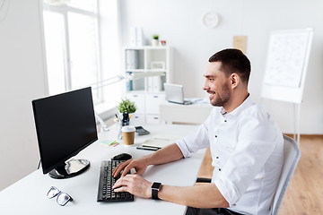 Image showing businessman typing on computer keyboard at office