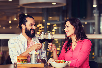 Image showing happy couple dining and drink wine at restaurant