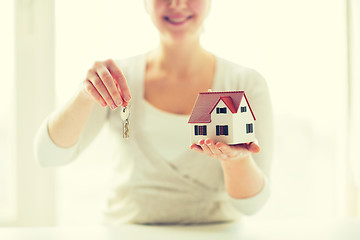 Image showing close up of woman holding house model and keys