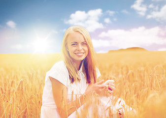 Image showing happy woman with smartphone and earphones