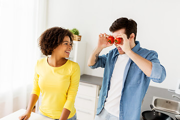 Image showing happy couple cooking food and having fun at home