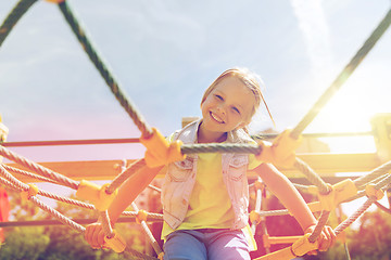 Image showing happy little girl climbing on children playground