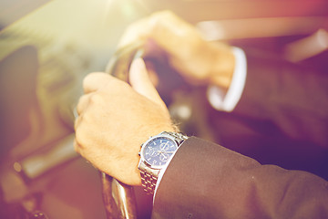 Image showing senior businessman hands driving car