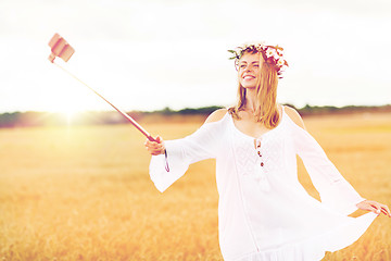 Image showing happy young woman taking selfie by smartphone