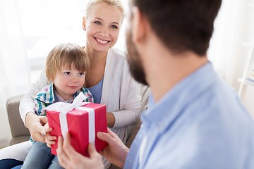 Image showing happy family with birthday gift at home