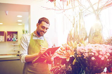 Image showing florist man with clipboard at flower shop