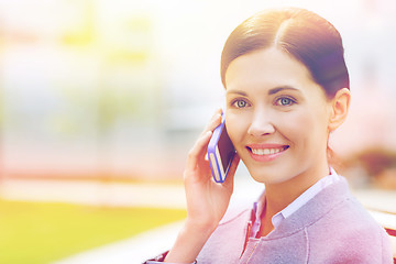 Image showing young smiling businesswoman calling on smartphone