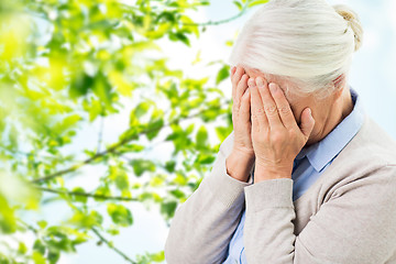 Image showing senior woman suffering from headache or grief