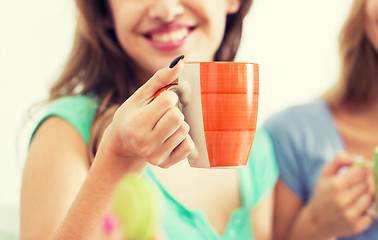 Image showing happy woman or teen girl drinking tea from cup