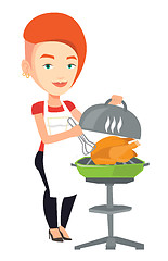 Image showing Woman cooking chicken on barbecue grill.