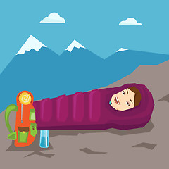 Image showing Woman resting in sleeping bag in the mountains.