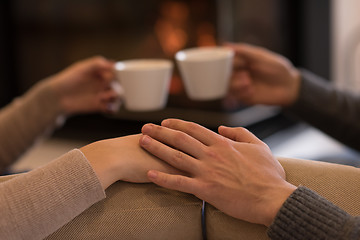 Image showing Young couple  in front of fireplace