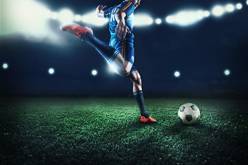 Image showing The active player of football at stadium in motion