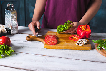 Image showing Closeup hand of chef baker making pizza at kitchen