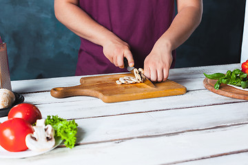 Image showing Closeup hand of chef baker making pizza at kitchen