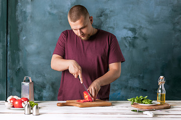 Image showing Closeup hand of chef baker making pizza at kitchen