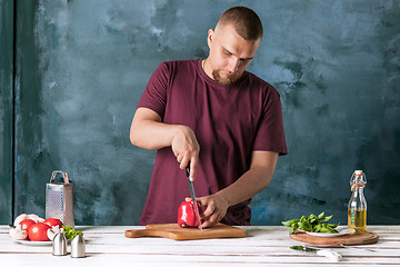 Image showing Closeup hand of chef baker making pizza at kitchen