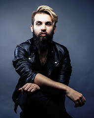 Image showing portrait of young bearded hipster guy smiling on gray dark background close up, brutal modern man, lifestyle people concept