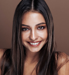 Image showing cute happy young indian real woman in studio close up smiling, fashion mulatto, lifestyle people concept