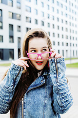 Image showing young pretty hipster girl student with coffee cup posing adorable smiling, lifestyle people concept outdoor