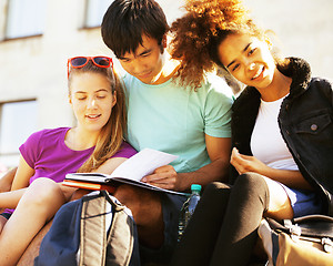 Image showing cute group of teenages at the building of university with books 