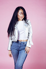 Image showing young pretty smiling asian korean girl wearing modern fashion clothers on pink background, lifestyle people concept