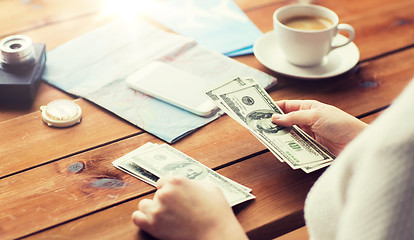 Image showing close up of traveler hands counting dollar money