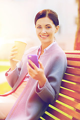 Image showing smiling woman with coffee and smartphone