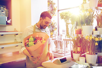 Image showing florist man or seller at flower shop cashbox