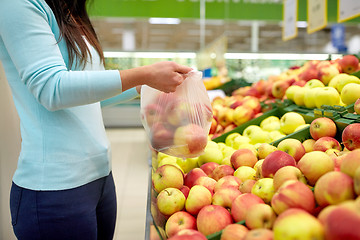 Image showing woman with bag buying apples at grocery store