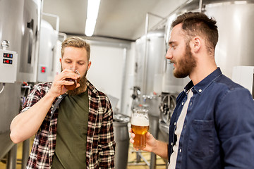 Image showing men drinking and testing craft beer at brewery